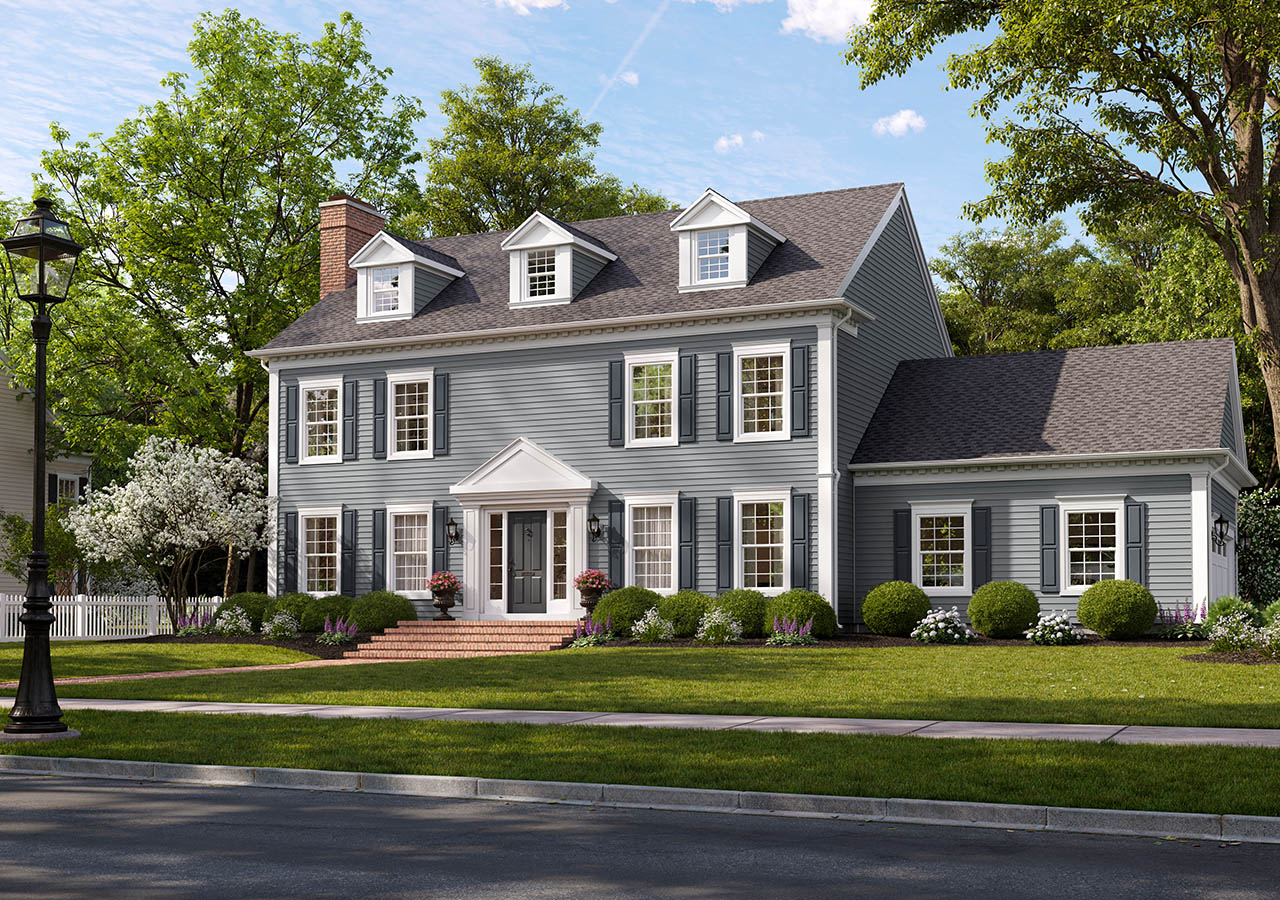 Elegant gray colonial-style house with white trim and lush green lawn.