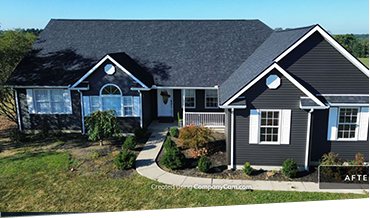 Modern single-story black house with white trim and landscaped yard.
